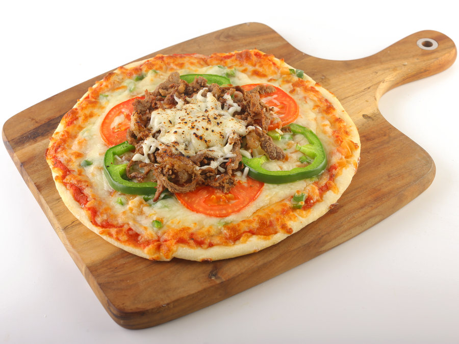 Lamb pizza on a wooden board