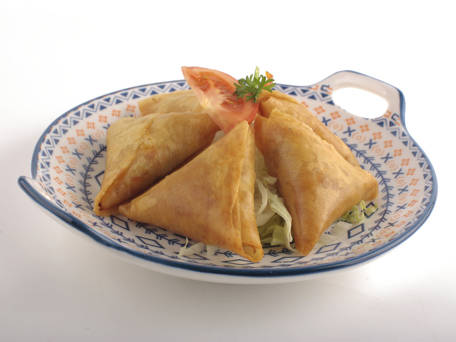 Golden samboosa on a patterned plate